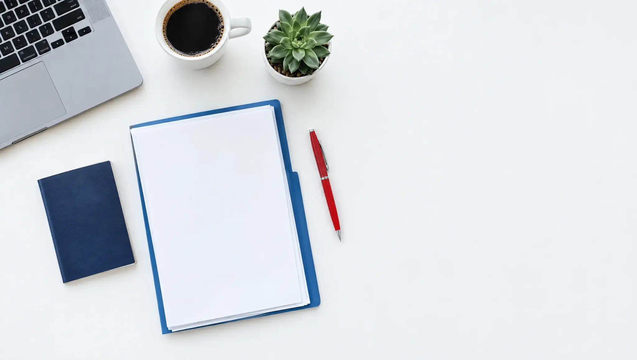 A desk seen from above with a passport, a folder of papers, a red pen and a coffee